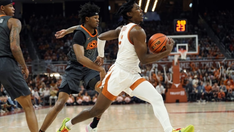 Jan 24, 2023; Austin, Texas, USA; Texas Longhorns guard Marcus Carr (5) drives to the basket past Oklahoma State Cowboys guard Woody Newton (4) during the first half at Moody Center. Mandatory Credit: Scott Wachter-USA TODAY Sports