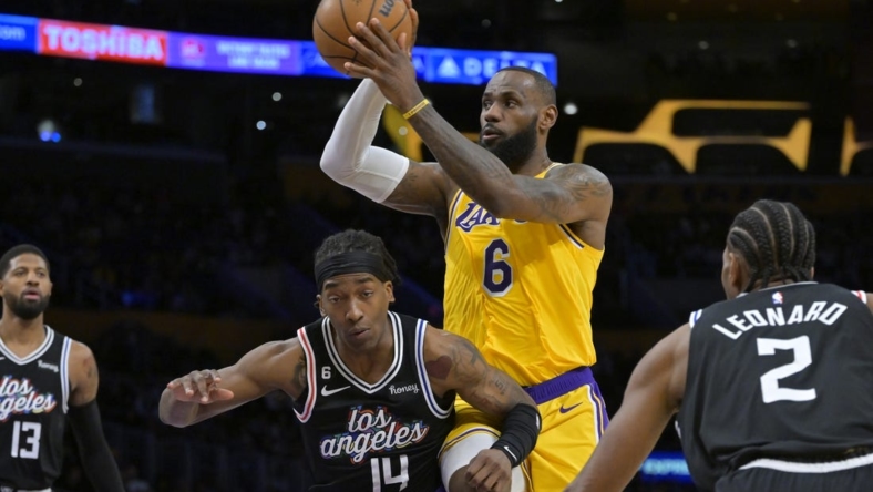 Jan 24, 2023; Los Angeles, California, USA; Los Angeles Lakers forward LeBron James (6) passes the ball over Los Angeles Clippers guard Terance Mann (14) as guard Paul George (13) and forward Kawhi Leonard (2) look on in the first quarter at Crypto.com Arena. Mandatory Credit: Jayne Kamin-Oncea-USA TODAY Sports