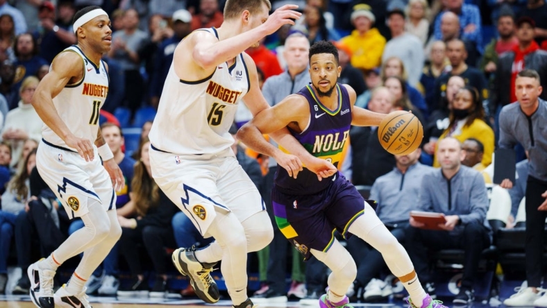 Jan 24, 2023; New Orleans, Louisiana, USA; New Orleans Pelicans guard CJ McCollum (3) fights for position against Denver Nuggets center Nikola Jokic (15) during the fourth quarter at Smoothie King Center. Mandatory Credit: Andrew Wevers-USA TODAY Sports