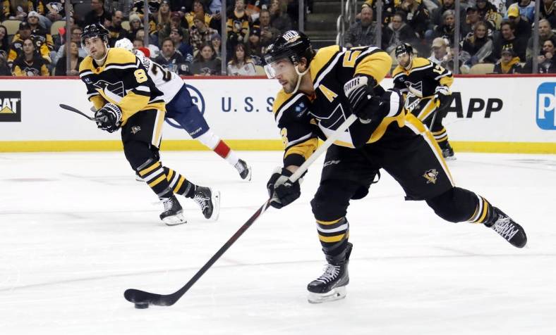 Jan 24, 2023; Pittsburgh, Pennsylvania, USA; Pittsburgh Penguins defenseman Kris Letang (58) moves the puck against the Florida Panthers during the second period at PPG Paints Arena. Pittsburgh won 7-6 in overtime. Mandatory Credit: Charles LeClaire-USA TODAY Sports