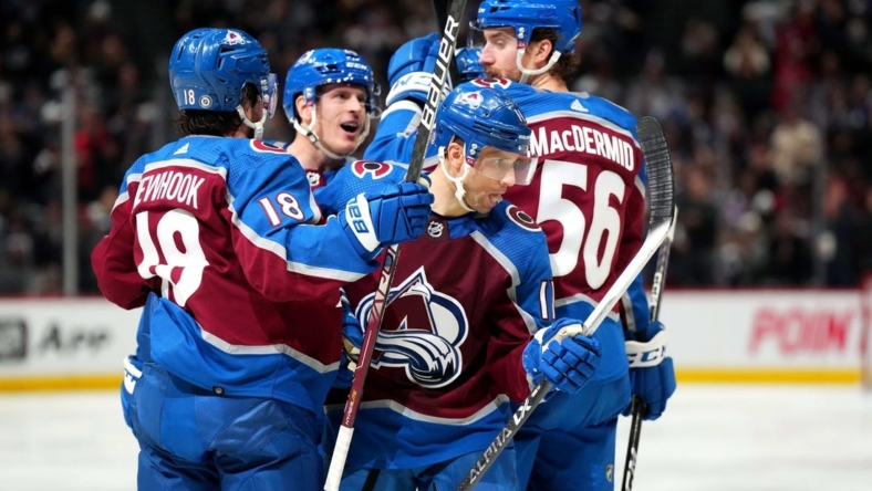 Jan 24, 2023; Denver, Colorado, USA; Colorado Avalanche center Andrew Cogliano (11) celebrates his goal with center Alex Newhook (18) and defenseman Kurtis MacDermid (56) in the second period against the Washington Capitals at Ball Arena. Mandatory Credit: Ron Chenoy-USA TODAY Sports