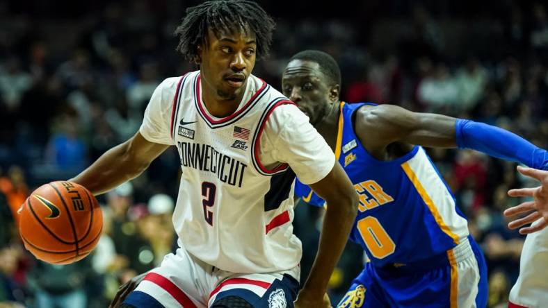 Jan 25, 2023; Storrs, Connecticut, USA; UConn Huskies guard Tristen Newton (2) drives the ball against Xavier Musketeers guard Souley Boum (0) in the first half at Harry A. Gampel Pavilion. Mandatory Credit: David Butler II-USA TODAY Sports