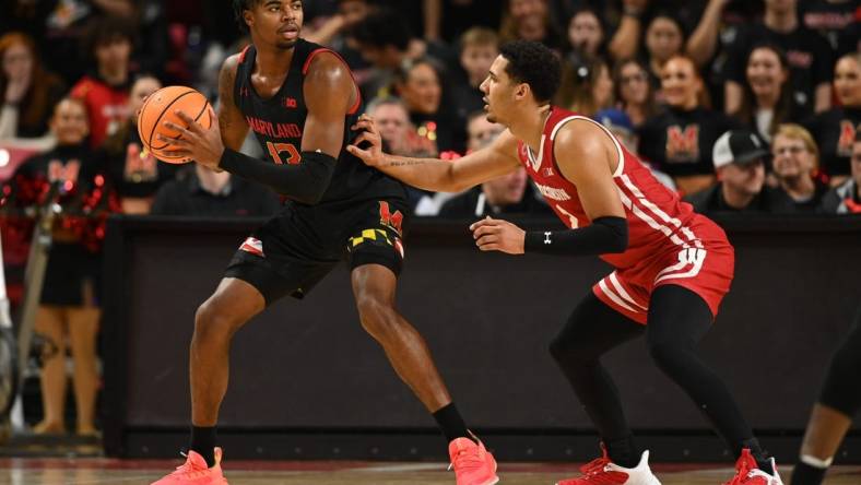 Jan 25, 2023; College Park, Maryland, USA;  Maryland Terrapins guard Hakim Hart (13) looks to move the ball as Wisconsin Badgers guard Jordan Davis (2) defends during the first half at Xfinity Center. Mandatory Credit: Tommy Gilligan-USA TODAY Sports