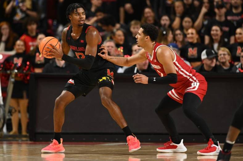 Jan 25, 2023; College Park, Maryland, USA;  Maryland Terrapins guard Hakim Hart (13) looks to move the ball as Wisconsin Badgers guard Jordan Davis (2) defends during the first half at Xfinity Center. Mandatory Credit: Tommy Gilligan-USA TODAY Sports