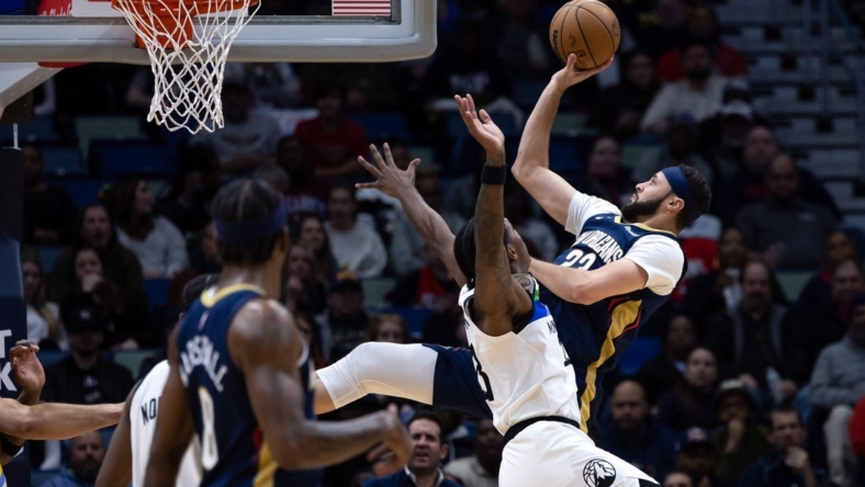 Jan 25, 2023; New Orleans, Louisiana, USA;  New Orleans Pelicans forward Larry Nance Jr. (22) shoots a jump shot against Minnesota Timberwolves forward Jaden McDaniels (3) during the first half at Smoothie King Center. Mandatory Credit: Stephen Lew-USA TODAY Sports