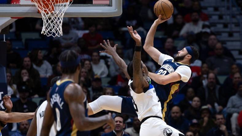 Jan 25, 2023; New Orleans, Louisiana, USA;  New Orleans Pelicans forward Larry Nance Jr. (22) shoots a jump shot against Minnesota Timberwolves forward Jaden McDaniels (3) during the first half at Smoothie King Center. Mandatory Credit: Stephen Lew-USA TODAY Sports