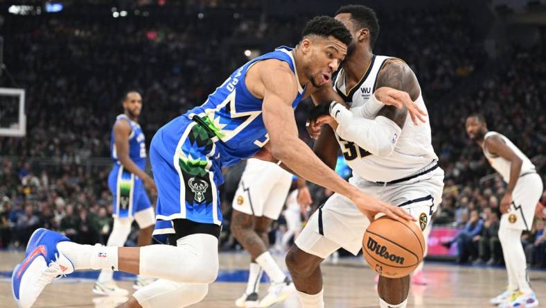 Jan 25, 2023; Milwaukee, Wisconsin, USA; Milwaukee Bucks forward Giannis Antetokounmpo (34) drives to the basket against Denver Nuggets forward Jeff Green (32) in the first half at Fiserv Forum. Mandatory Credit: Michael McLoone-USA TODAY Sports