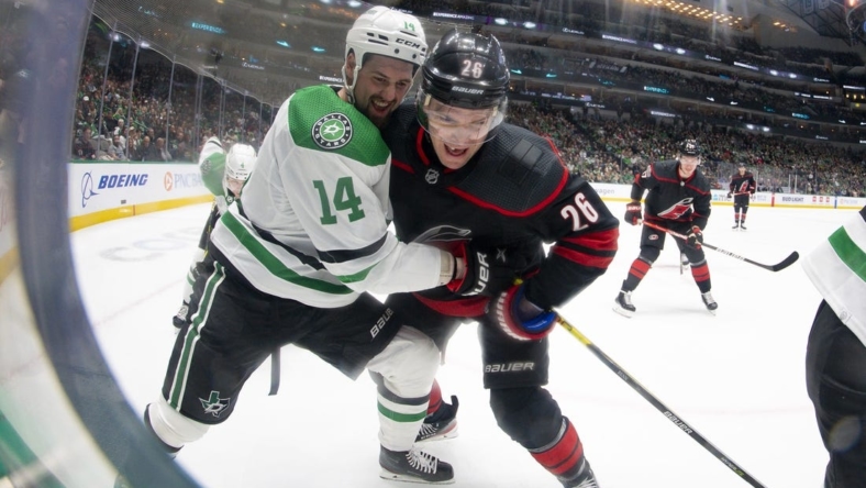 Jan 25, 2023; Dallas, Texas, USA; Dallas Stars left wing Jamie Benn (14) and Carolina Hurricanes center Paul Stastny (26) battle for control of the puck in the Stars zone during the first period at the American Airlines Center. Mandatory Credit: Jerome Miron-USA TODAY Sports