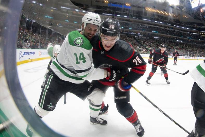 Jan 25, 2023; Dallas, Texas, USA; Dallas Stars left wing Jamie Benn (14) and Carolina Hurricanes center Paul Stastny (26) battle for control of the puck in the Stars zone during the first period at the American Airlines Center. Mandatory Credit: Jerome Miron-USA TODAY Sports