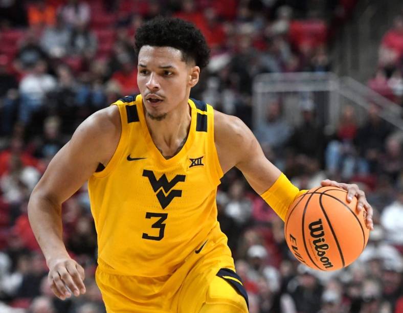 West Virginia's forward Tre Mitchell (3) dribbles the ball against Texas Tech in a Big 12 basketball game, Wednesday, Jan. 25, 2023, at United Supermarkets Arena.
