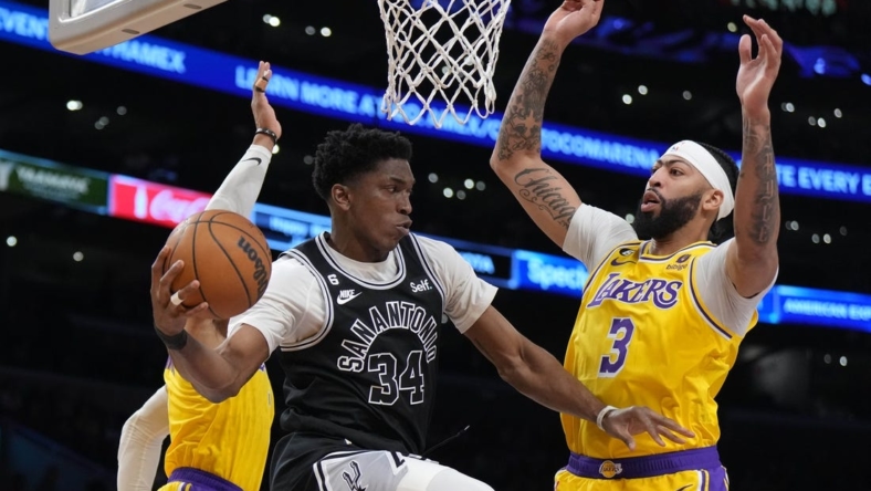 Jan 25, 2023; Los Angeles, California, USA; San Antonio Spurs forward Stanley Johnson (34) passes the ball against Los Angeles Lakers forward Anthony Davis (3) and guard Russell Westbrook (0) in the first half at Crypto.com Arena. Mandatory Credit: Kirby Lee-USA TODAY Sports