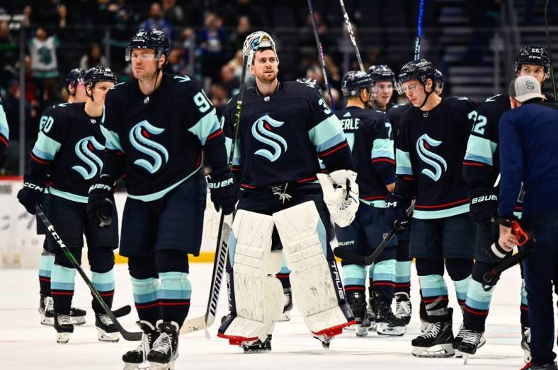 Jan 25, 2023; Seattle, Washington, USA; Seattle Kraken players celebrate after defeating the Vancouver Canucks at Climate Pledge Arena. Seattle defeated Vancouver 6-1. Mandatory Credit: Steven Bisig-USA TODAY Sports