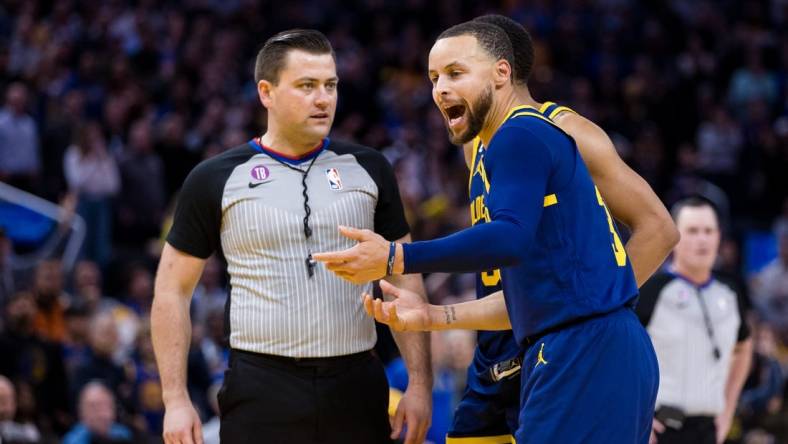 Jan 25, 2023; San Francisco, California, USA;  Golden State Warriors guard Stephen Curry (30) argues with official Matt Boland after being ejected for throwing his mouth guard during the second half against the Memphis Grizzlies at Chase Center. Mandatory Credit: John Hefti-USA TODAY Sports