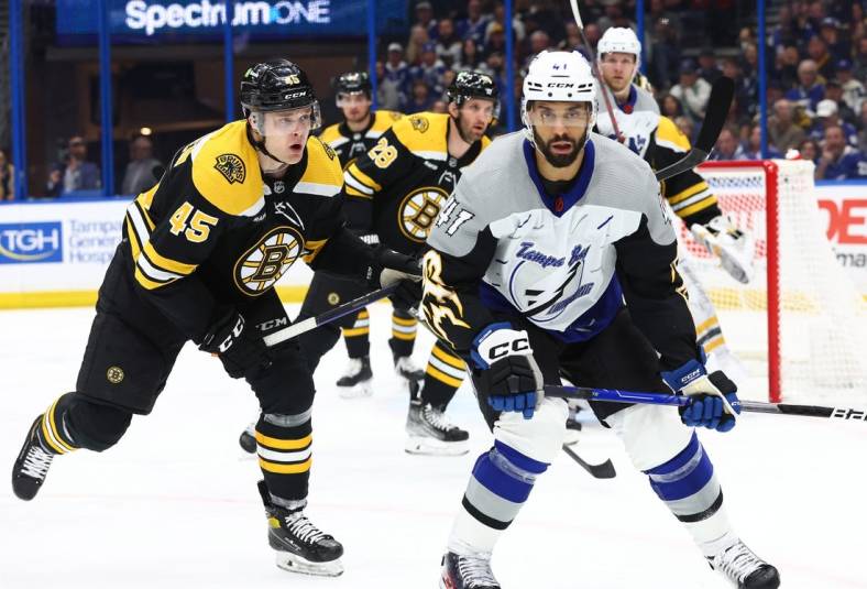 Jan 26, 2023; Tampa, Florida, USA; Tampa Bay Lightning left wing Pierre-Edouard Bellemare (41) and Boston Bruins left wing Joona Koppanen (45) skate after the puck during the first period  at Amalie Arena. Mandatory Credit: Kim Klement-USA TODAY Sports