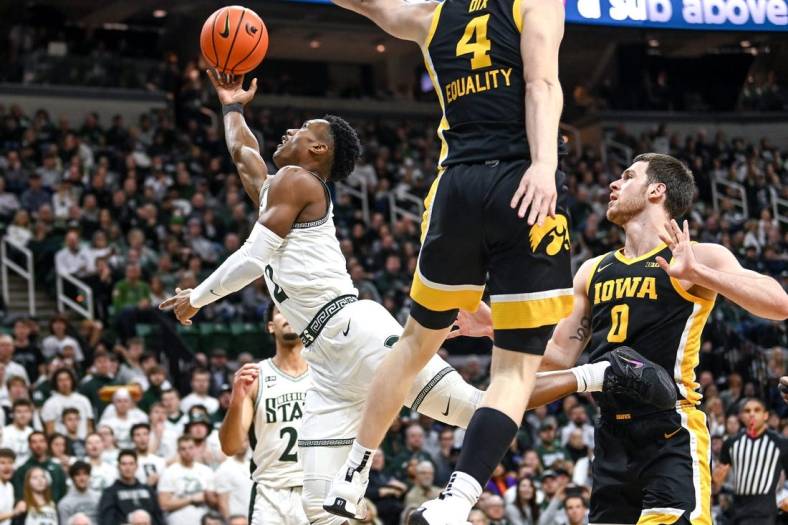 Michigan State's Tyson Walker, left, shoots a layup as Iowa's Filip Rebraca defends during the first half on Thursday, Jan. 26, 2023, at the Breslin Center in Lansing.

230126 Msu Iowa Bball 059a