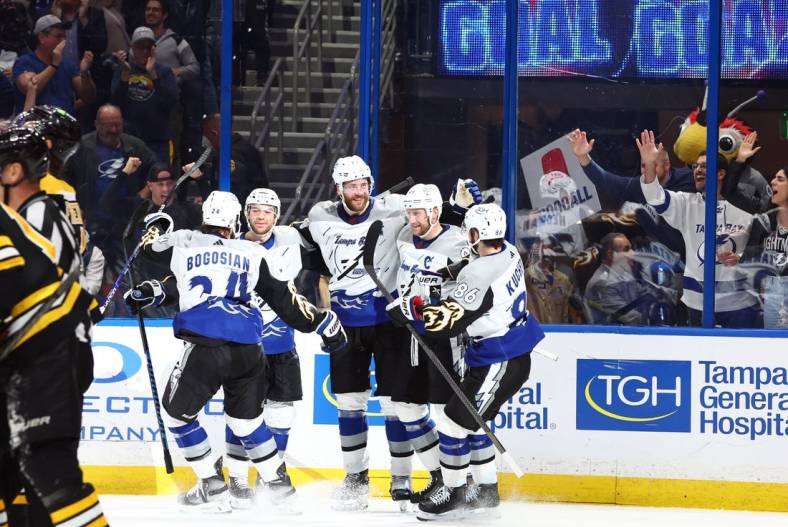 Jan 26, 2023; Tampa, Florida, USA; Tampa Bay Lightning defenseman Victor Hedman (77) is congratulated after he scored a goal against the Boston Bruins during the third period at Amalie Arena. Mandatory Credit: Kim Klement-USA TODAY Sports