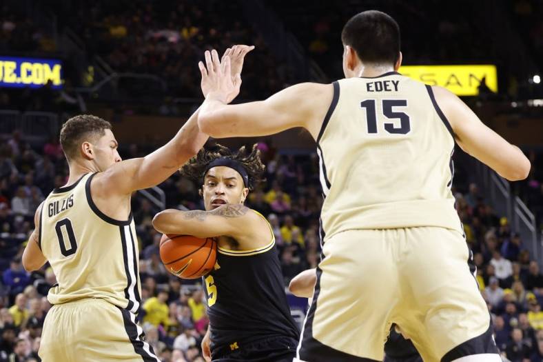 Jan 26, 2023; Ann Arbor, Michigan, USA;  Michigan Wolverines forward Terrance Williams II (5) is defended by Purdue Boilermakers forward Mason Gillis (0) and center Zach Edey (15) in the first half at Crisler Center. Mandatory Credit: Rick Osentoski-USA TODAY Sports