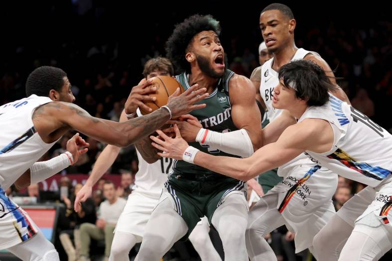 Jan 26, 2023; Brooklyn, New York, USA; Detroit Pistons forward Saddiq Bey (41) drives to the basket against Brooklyn Nets guard Kyrie Irving (11) and forward Joe Harris (12) and center Nic Claxton (33) and forward Yuta Watanabe (18) during the fourth quarter at Barclays Center. Mandatory Credit: Brad Penner-USA TODAY Sports