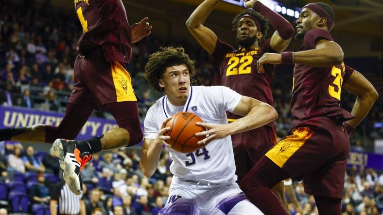 Jan 26, 2023; Seattle, Washington, USA; Washington Huskies center Braxton Meah (34) pump fakes against Arizona State Sun Devils guard Desmond Cambridge Jr. (4), forward Warren Washington (22) and guard Devan Cambridge (35) during the first half at Alaska Airlines Arena at Hec Edmundson Pavilion. Mandatory Credit: Joe Nicholson-USA TODAY Sports