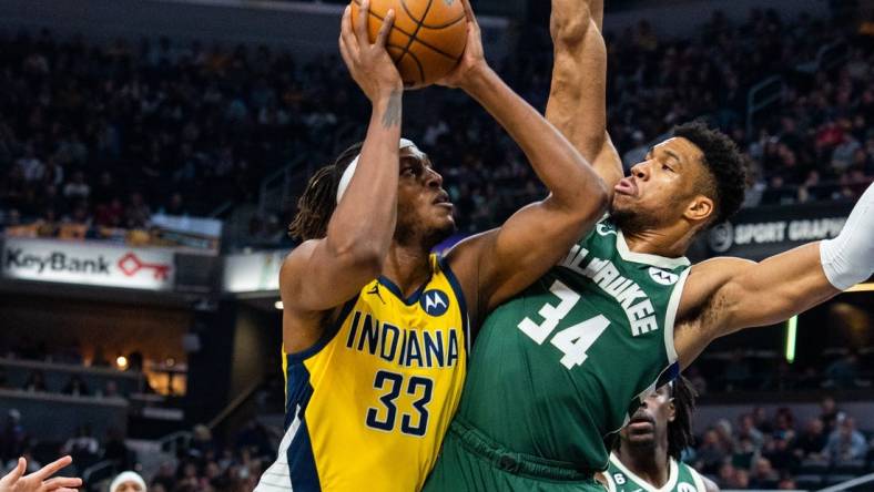 Jan 27, 2023; Indianapolis, Indiana, USA; Indiana Pacers center Myles Turner (33) shoots the ball while Milwaukee Bucks forward Giannis Antetokounmpo (34) defends in the first quarter at Gainbridge Fieldhouse. Mandatory Credit: Trevor Ruszkowski-USA TODAY Sports