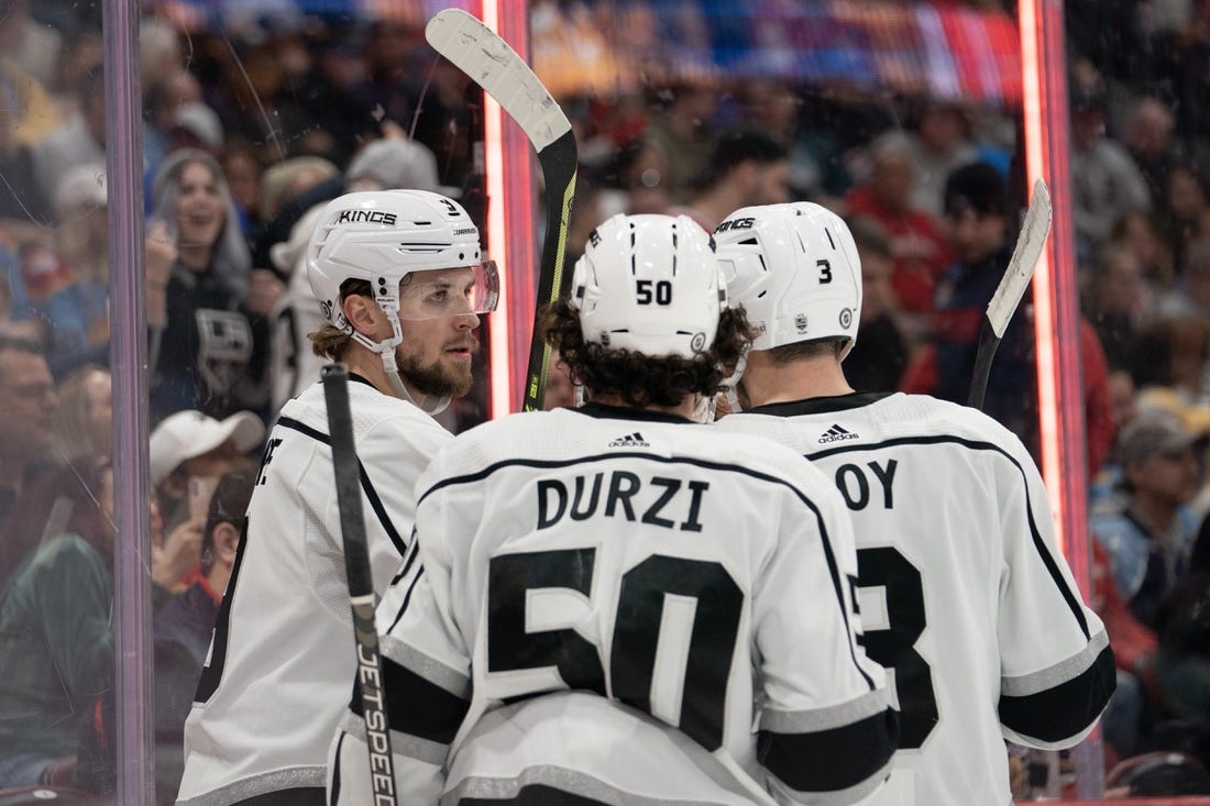 Jan 27, 2023; Sunrise, Florida, USA; Los Angeles Kings right wing Adrian Kempe (9) celebrates a goal with defenseman Matt Roy (3) and defenseman Sean Durzi (50) during the first period `against the Florida Panthers at FLA Live Arena. Mandatory Credit: Jason Mowry-USA TODAY Sports
