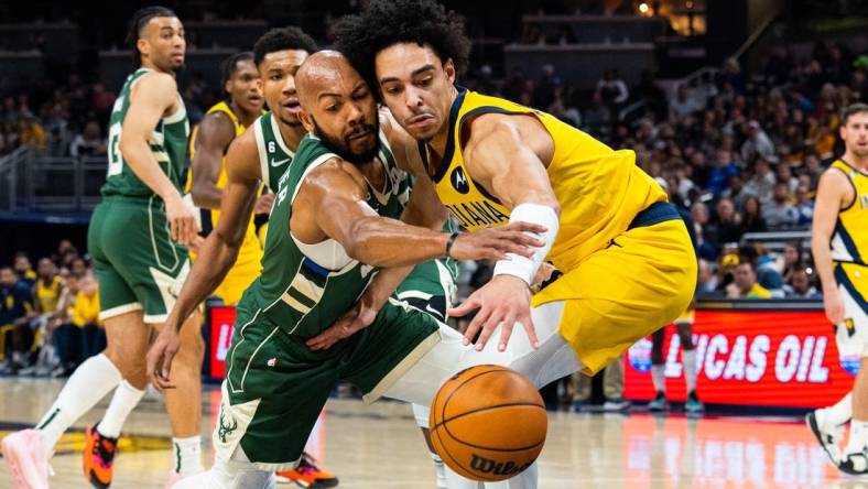 Jan 27, 2023; Indianapolis, Indiana, USA; Milwaukee Bucks guard Jevon Carter (5) steals the ball from Indiana Pacers guard Andrew Nembhard (2)  in the second quarter at Gainbridge Fieldhouse. Mandatory Credit: Trevor Ruszkowski-USA TODAY Sports