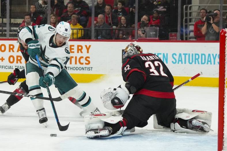 Jan 27, 2023; Raleigh, North Carolina, USA;  San Jose Sharks left wing Evgeny Svechnikov (10) misses on his shot attempt against Carolina Hurricanes goaltender Antti Raanta (32) during the second period at PNC Arena. Mandatory Credit: James Guillory-USA TODAY Sports