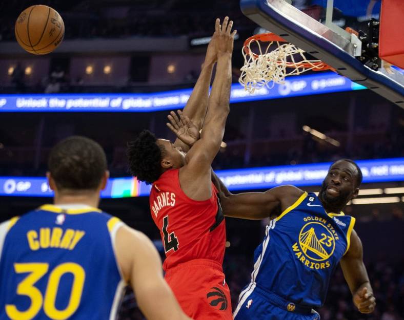 Jan 27, 2023; San Francisco, California, USA; Golden State Warriors forward Draymond Green (23) rejects a shot by Toronto Raptors forward Scottie Barnes (4) during the first quarter at Chase Center. Mandatory Credit: D. Ross Cameron-USA TODAY Sports