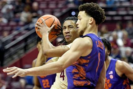 Jan 28, 2023; Tallahassee, Florida, USA; Florida State Seminoles guard Caleb Mills (4) controls the ball against Clemson Tigers guard Chase Hunter (1) during the first half at Donald L. Tucker Center. Mandatory Credit: Melina Myers-USA TODAY Sports