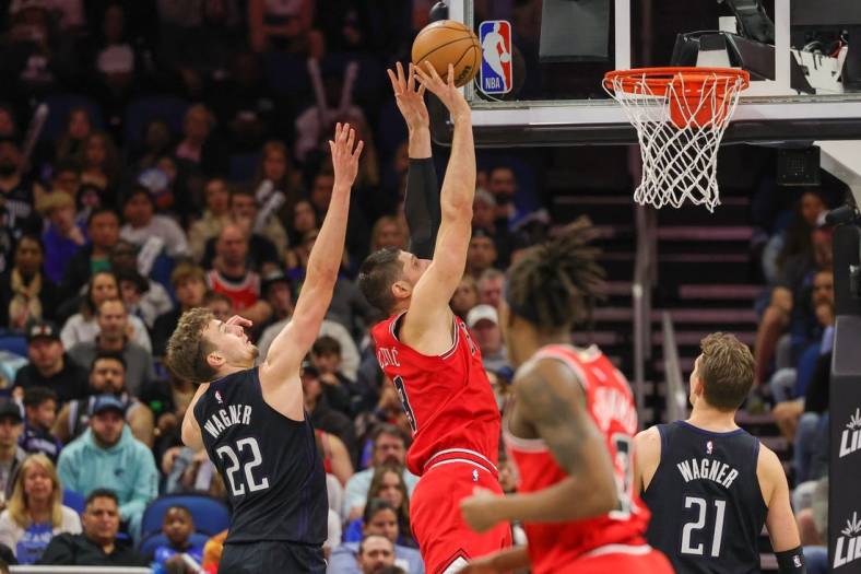 Jan 28, 2023; Orlando, Florida, USA; Chicago Bulls center Nikola Vucevic (9) goes to the basket in front of Orlando Magic forward Franz Wagner (22) during the second quarter at Amway Center. Mandatory Credit: Mike Watters-USA TODAY Sports