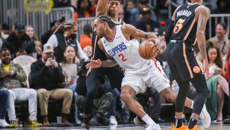 Jan 28, 2023; Atlanta, Georgia, USA; LA Clippers forward Kawhi Leonard (2) is defended by Atlanta Hawks forward De'Andre Hunter (12) in the first quarter at State Farm Arena. Mandatory Credit: Brett Davis-USA TODAY Sports