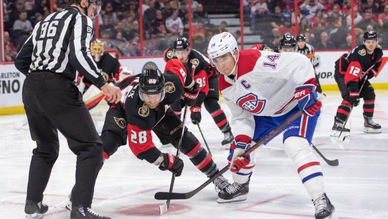 Jan 28, 2023; Ottawa, Ontario, CAN; Ottawa Senators right wing Claude Giroux (28) faces off against Montreal Canadiens center Nick Suzuki (14) in the second period at the Canadian Tire Centre. Mandatory Credit: Marc DesRosiers-USA TODAY Sports