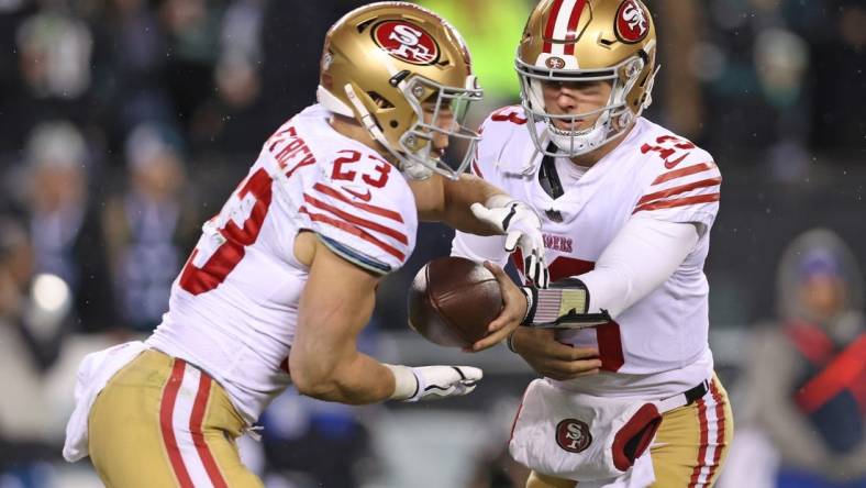 Jan 29, 2023; Philadelphia, Pennsylvania, USA; San Francisco 49ers quarterback Brock Purdy (13) hands off to running back Christian McCaffrey (23) against the Philadelphia Eagles during the fourth quarter in the NFC Championship game at Lincoln Financial Field. Mandatory Credit: Bill Streicher-USA TODAY Sports