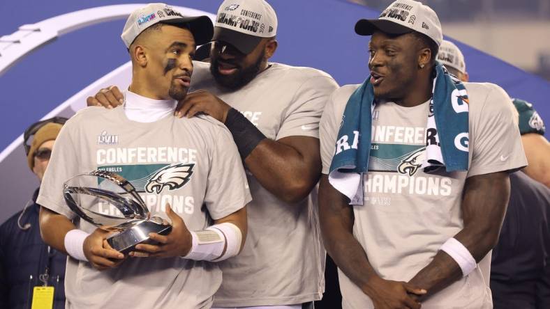 Jan 29, 2023; Philadelphia, Pennsylvania, USA; Philadelphia Eagles quarterback Jalen Hurts (1), defensive tackle Fletcher Cox (91) and wide receiver A.J. Brown (11) during the NFC Championship trophy presentation after win against the San Francisco 49ers in the NFC Championship game at Lincoln Financial Field. Mandatory Credit: Bill Streicher-USA TODAY Sports