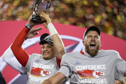 Jan 29, 2023; Kansas City, Missouri, USA; Kansas City Chiefs quarterback Patrick Mahomes (15) raises the Lamar Hunt Trophy with tight end Travis Kelce (87) after the AFC championship NFL game between the Cincinnati Bengals and the Kansas City Chiefs, Sunday, Jan. 29, 2023, at Arrowhead Stadium in Kansas City, Mo. The Kansas City Chiefs advanced to the Super Bowl with a 23-20 win over the Bengals. Mandatory Credit: Sam Greene-USA TODAY Sports
