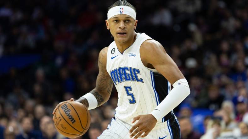 Jan 30, 2023; Philadelphia, Pennsylvania, USA; Orlando Magic forward Paolo Banchero (5) dribbles the ball against the Philadelphia 76ers during the first quarter at Wells Fargo Center. Mandatory Credit: Bill Streicher-USA TODAY Sports