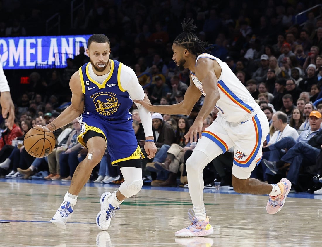 Jan 30, 2023; Oklahoma City, Oklahoma, USA; Golden State Warriors guard Stephen Curry (30) dribbles the ball down the court against Oklahoma City Thunder guard Isaiah Joe (11) during the second quarter at Paycom Center. Mandatory Credit: Alonzo Adams-USA TODAY Sports