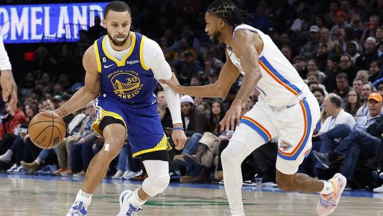 Jan 30, 2023; Oklahoma City, Oklahoma, USA; Golden State Warriors guard Stephen Curry (30) dribbles the ball down the court against Oklahoma City Thunder guard Isaiah Joe (11) during the second quarter at Paycom Center. Mandatory Credit: Alonzo Adams-USA TODAY Sports
