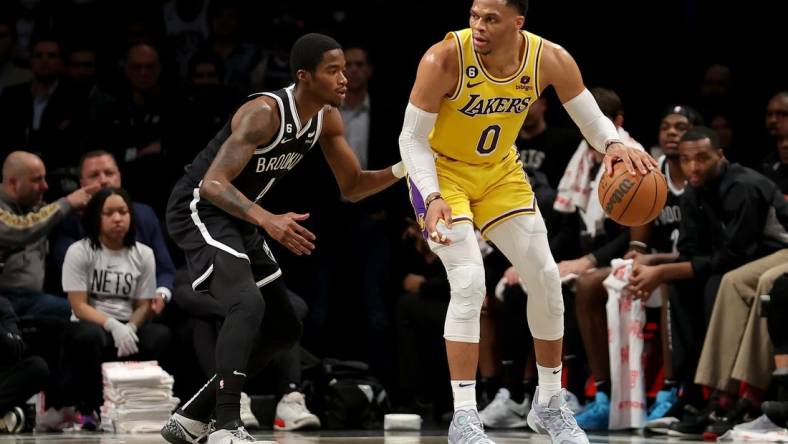 Jan 30, 2023; Brooklyn, New York, USA; Los Angeles Lakers guard Russell Westbrook (0) controls the ball against Brooklyn Nets guard Edmond Sumner (4) during the second quarter at Barclays Center. Mandatory Credit: Brad Penner-USA TODAY Sports