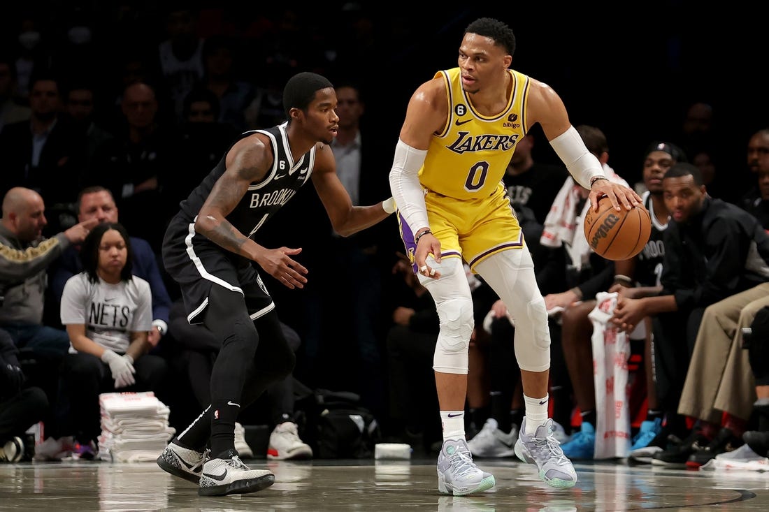 Jan 30, 2023; Brooklyn, New York, USA; Los Angeles Lakers guard Russell Westbrook (0) controls the ball against Brooklyn Nets guard Edmond Sumner (4) during the second quarter at Barclays Center. Mandatory Credit: Brad Penner-USA TODAY Sports