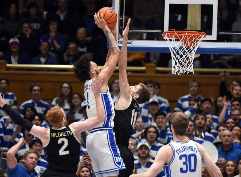 Jan 31, 2023; Durham, North Carolina, USA; Duke Blue Devils center Dereck Lively (1) shoots over Wake Forest Demon Deacons forward Andrew Carr (11) during the first half at Cameron Indoor Stadium. Mandatory Credit: Rob Kinnan-USA TODAY Sports