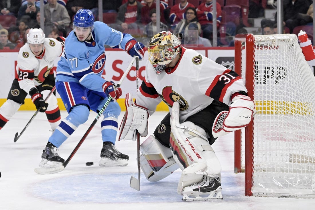 Jan 31, 2023; Montreal, Quebec, CAN; Ottawa Senators goaltender Anton Forsberg (31) stops Montreal Canadiens forward Kirby Dach (77) during the first period at the Bell Centre. Mandatory Credit: Eric Bolte-USA TODAY Sports