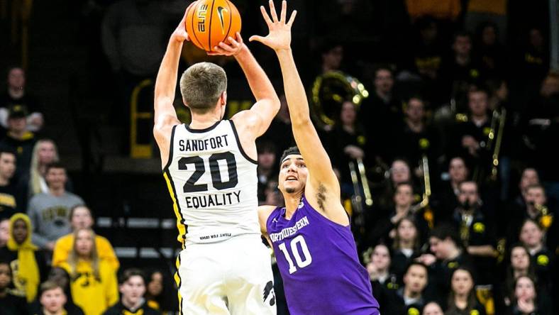 Iowa forward Payton Sandfort (20) makes a 3-point basket as Northwestern forward Tydus Verhoeven (10) defends during a NCAA Big Ten Conference men's basketball game, Tuesday, Jan. 31, 2023, at Carver-Hawkeye Arena in Iowa City, Iowa.

230131 N Western Iowa Mbb 034 Jpg