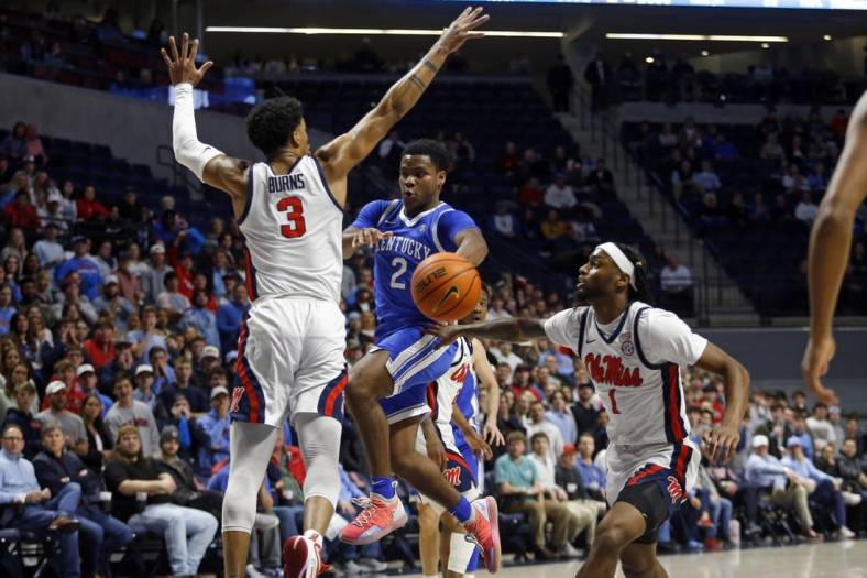 Jan 31, 2023; Oxford, Mississippi, USA; Kentucky Wildcats guard Sahvir Wheeler (2) passes the ball as Mississippi Rebels forward Myles Burns (3) and guard Amaree Abram (1) defend during the first half at The Sandy and John Black Pavilion at Ole Miss. Mandatory Credit: Petre Thomas-USA TODAY Sports