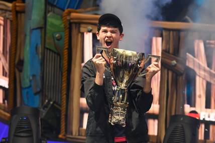 Jul 28, 2019; Flushing, NY, USA; Bugha celebrates his win as the first solo World Champion at the Fortnite World Cup Finals e-sports event at Arthur Ashe Stadium. Mandatory Credit: Dennis Schneidler-USA TODAY Sports