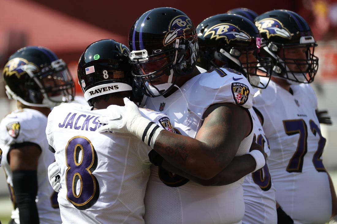 Oct 4, 2020; Landover, Maryland, USA; Baltimore Ravens quarterback Lamar Jackson (8) hugs Ravens offensive tackle Orlando Brown (78) during warmups prior to the Ravens'game against the Washington Football Team at FedExField. Mandatory Credit: Geoff Burke-USA TODAY Sports