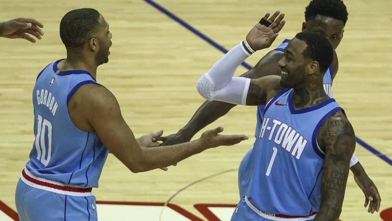 Jan 28, 2021; Houston, Texas, USA; Houston Rockets guard Eric Gordon (10) and guard John Wall (1) celebrate after a play during the fourth quarter against the Portland Trail Blazers at Toyota Center. Mandatory Credit: Troy Taormina-USA TODAY Sports