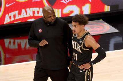 May 5, 2021; Atlanta, Georgia, USA; Atlanta Hawks coach Nate McMillan talks with guard Trae Young (11) during a time out of their game against the Phoenix Suns at State Farm Arena. Mandatory Credit: Jason Getz-USA TODAY Sports