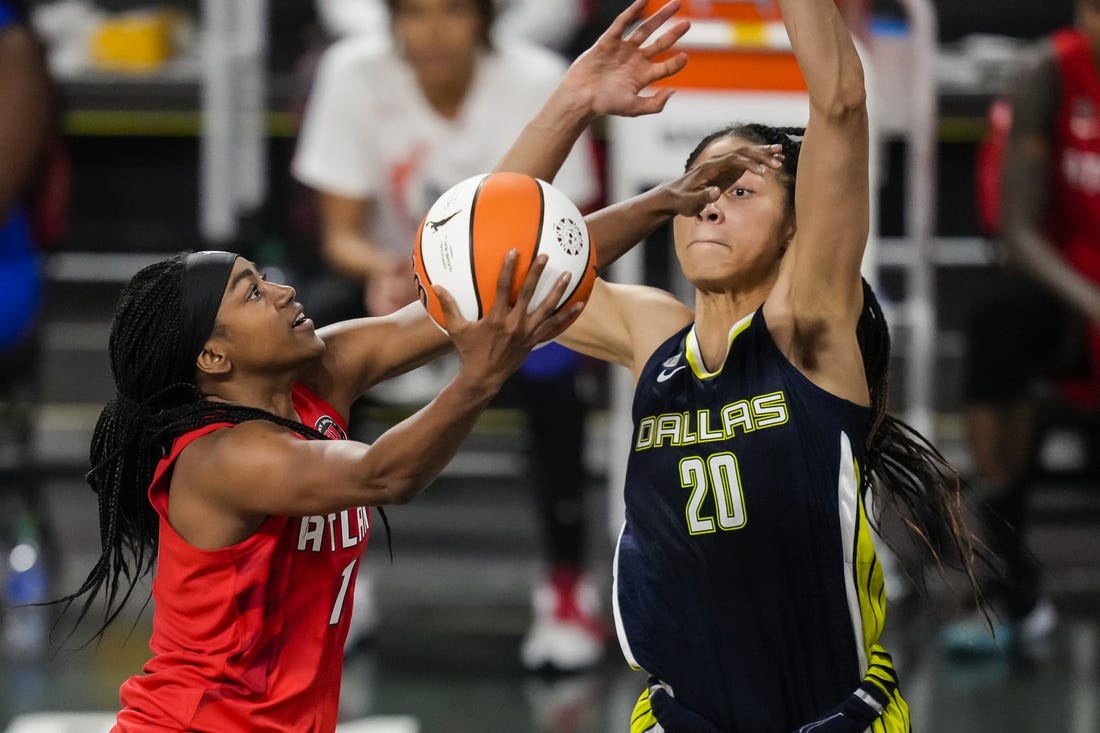 May 27, 2021; College Park, Georgia, USA; Atlanta Dream center/forward Elizabeth Williams (1) drives to the basket against Dallas Wings forward Isabelle Harrison (20) during the second half at Gateway Center Arena at College Park. Mandatory Credit: Dale Zanine-USA TODAY Sports