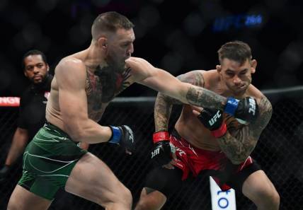 Jul 10, 2021; Las Vegas, Nevada, USA; Conor McGregor moves in for a hit against Dustin Poirier during UFC 264 at T-Mobile Arena. Mandatory Credit: Gary A. Vasquez-USA TODAY Sports